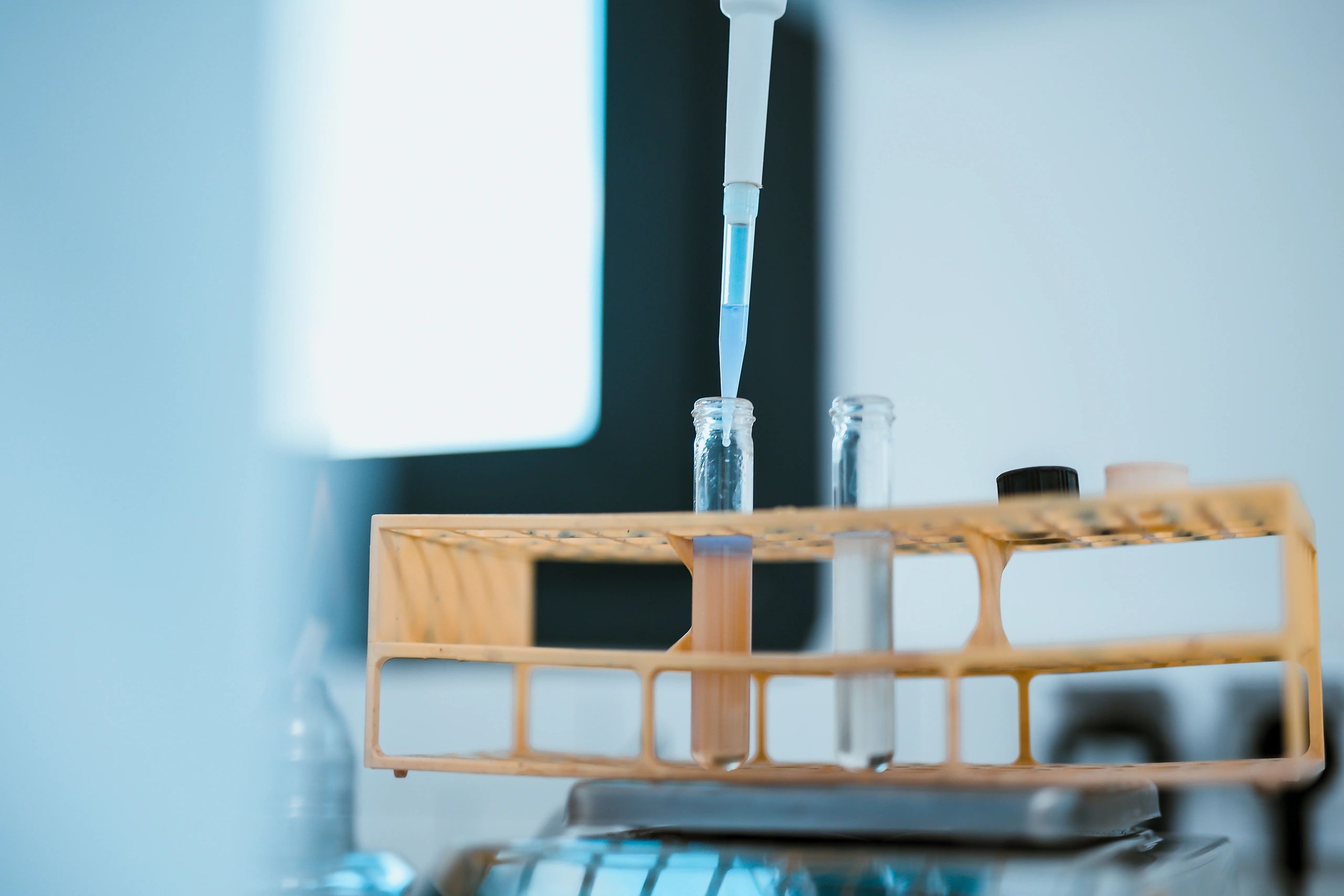 Scientist handling laboratory sample with protective equipment
